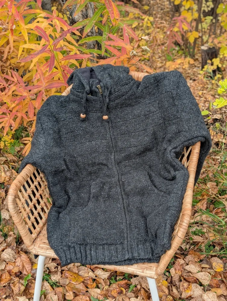 Dark gray textured knit calgary cardigan with attached hood and wooden toggle drawstrings made from new zealand wool