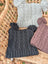 Three woolen heelah double pompom hats in gray charcoal and dusty rose with cable knit and fluffy pom poms