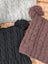 Three woolen heelah double pompom hats in gray black and brown with cable knit and fluffy double pompoms on top