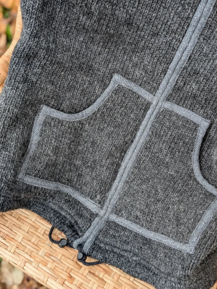 Gray heathered jasper vest made from soft zealand wool fleece with light gray stitched pockets and black drawstring ties