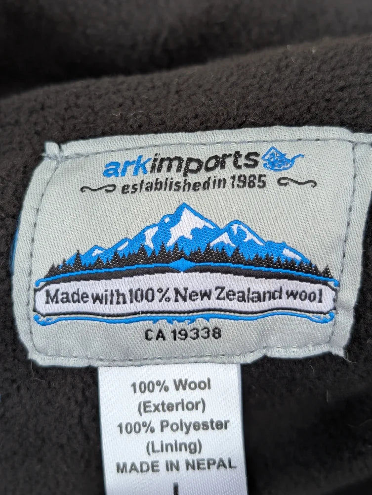 Gray woolen jasper vest label from ark imports showing soft fleece made with 100 percent new zealand wool