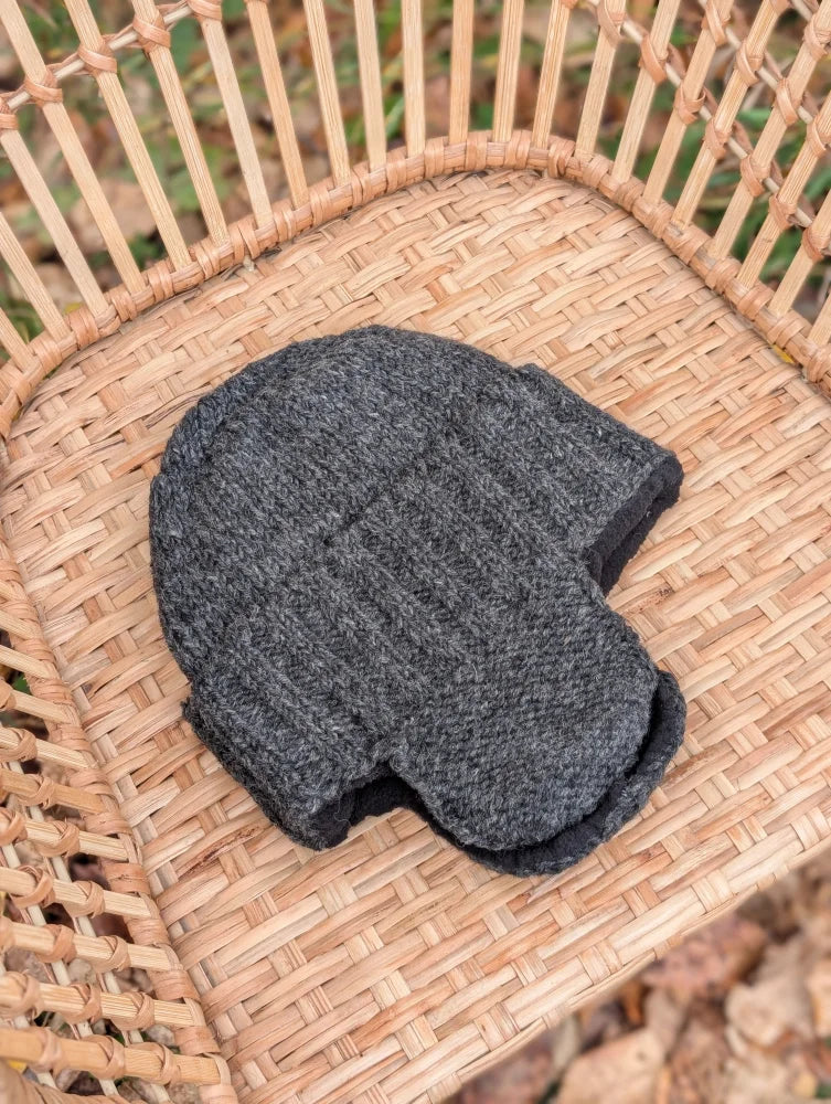 Dark gray woolen solo ear flap hat with ribbed texture and folded brim perfect as an ear flap hat