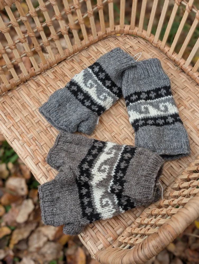 Gray knitted fingerless woolen wave hand warmers with black and white fair trade geometric patterns by angus oliver