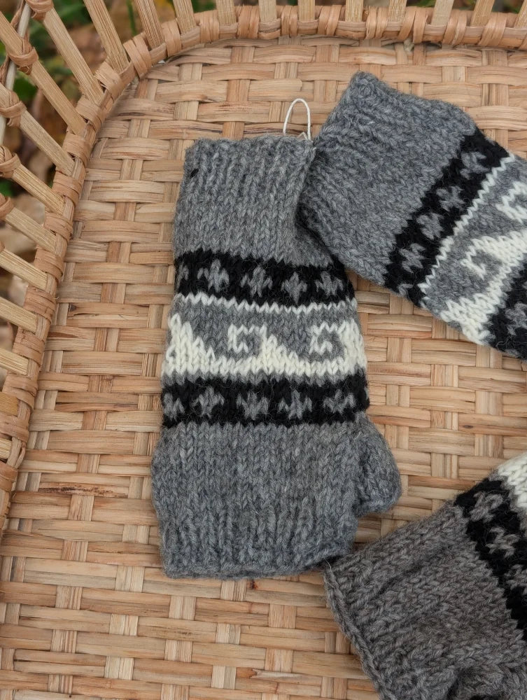 Gray knitted woolen wave hand warmers with black and white nordic patterns fair trade angus oliver fingerless mittens