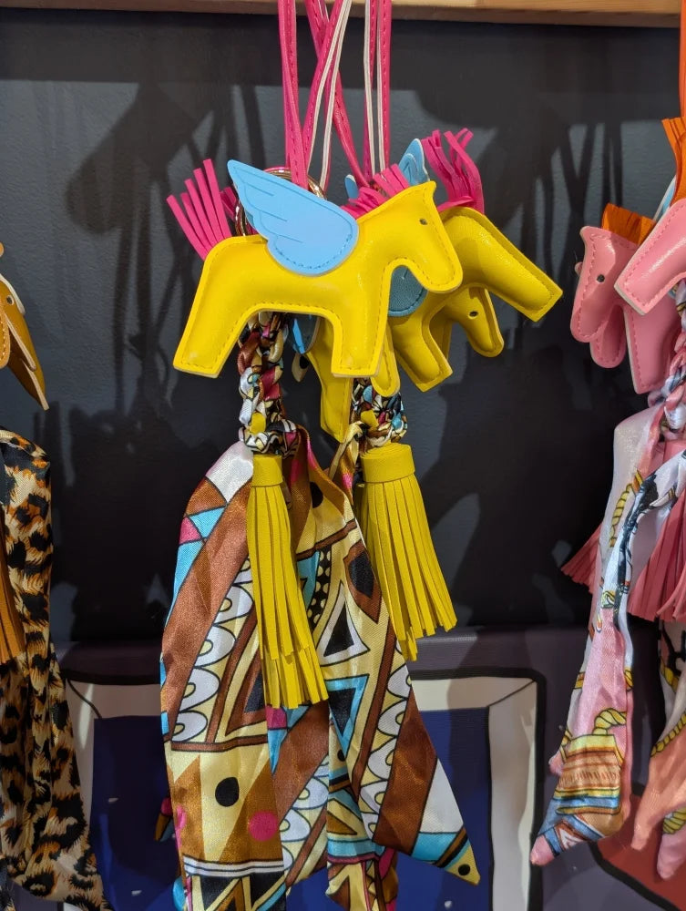 Yellow horse bag charm with blue wings and colorful scarf