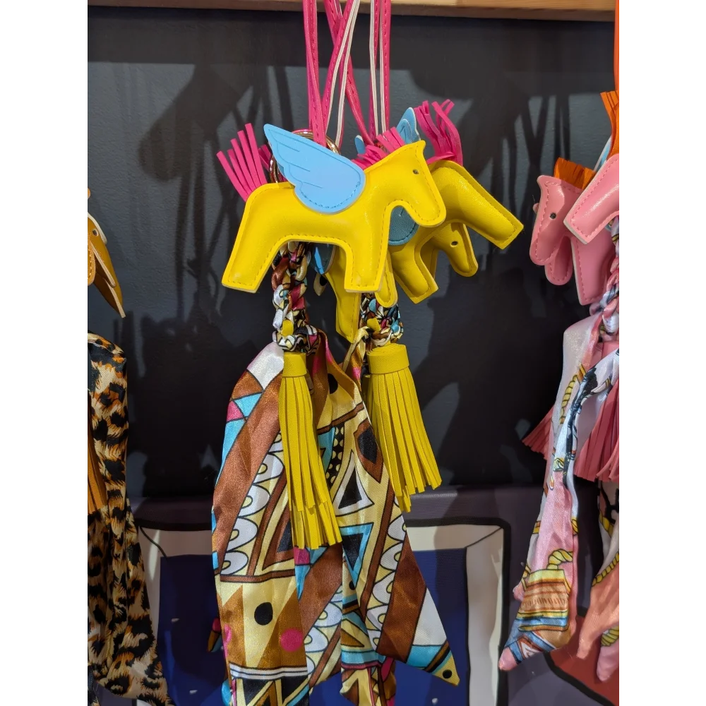 Yellow horse bag charm with blue wings and colorful scarf