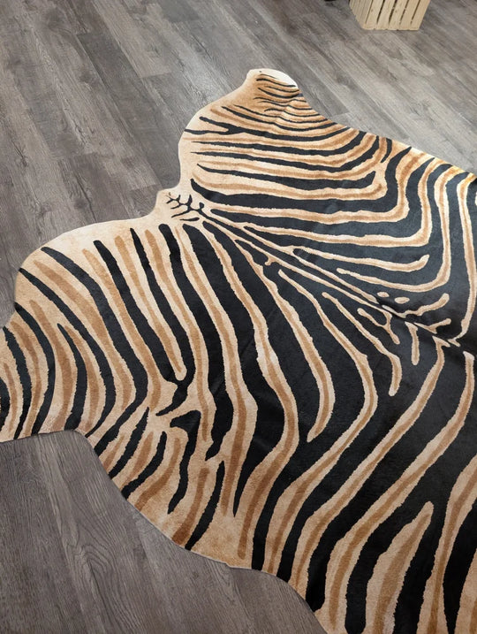 A plush angus oliver large cowhide rug with bold black and tan zebra print and unique characteristics