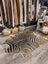 Black and tan zebra printed cowhide rug with unique characteristics from angus oliver large cowhide collection