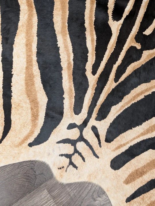 A large angus oliver plush faux leather rug with bold black and beige zebra stripes showing unique characteristics