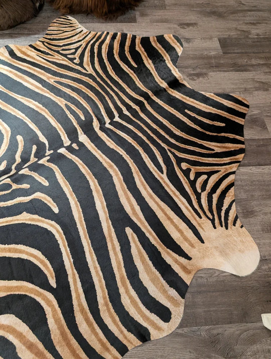 Black and tan zebra striped large cowhide rug with natural fur edge by angus oliver showing unique characteristics