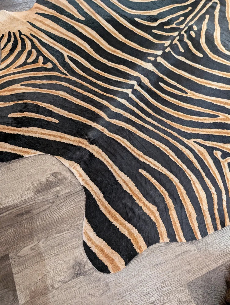 Gorgeous zebra printed cowhide rug with black and tan zebra stripes and unique characteristics by angus oliver