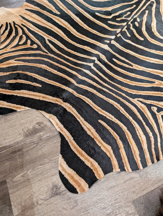 Gorgeous zebra printed cowhide rug with black and tan zebra stripes and unique characteristics by angus oliver