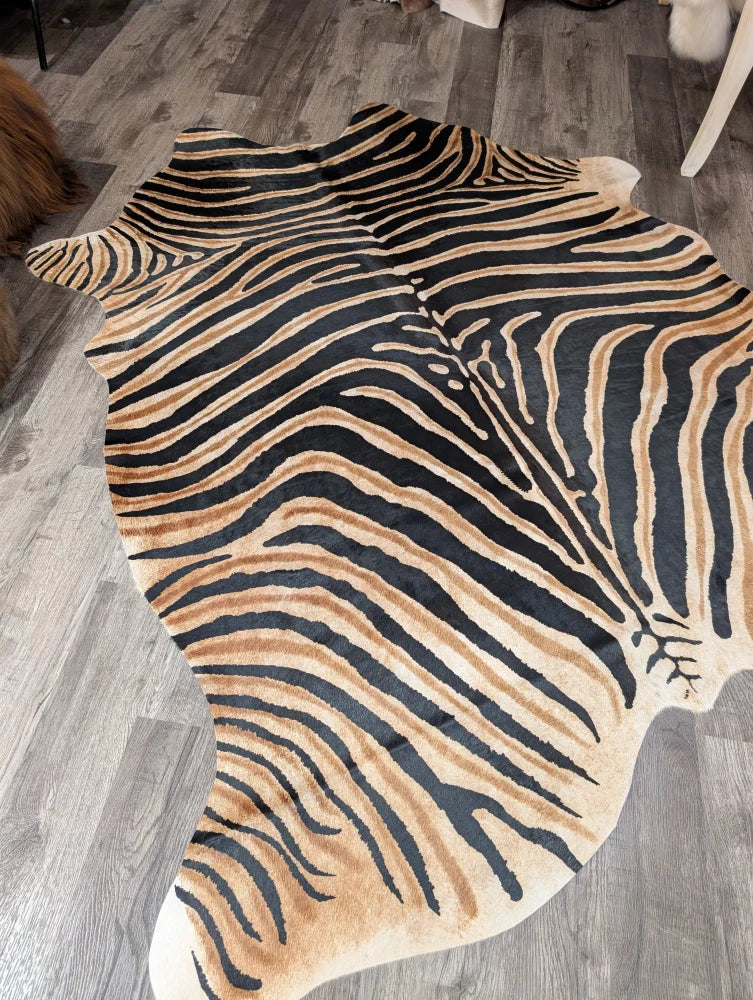 Gorgeous zebra printed cowhide rug by angus oliver with bold black and tan stripes and unique large cowhide shape