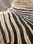 A gorgeous zebra printed cowhide rug by angus oliver with bold black and tan stripes and unique characteristics