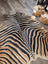 Gorgeous zebra printed large cowhide rug with black and tan zebra striped faux fur by angus oliver with unique characteristics