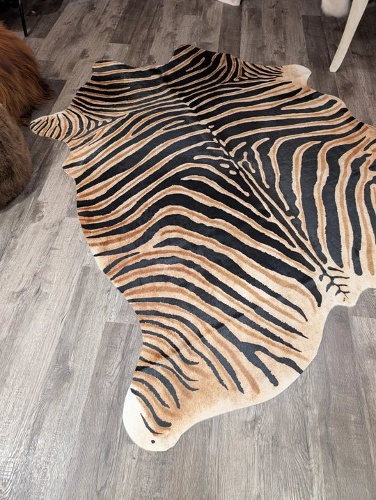 Gorgeous zebra printed large cowhide rug by angus oliver with bold black and tan stripes and unique characteristics