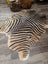 Gorgeous zebra printed cowhide rug by angus oliver with unique characteristics in bold black and tan faux leather