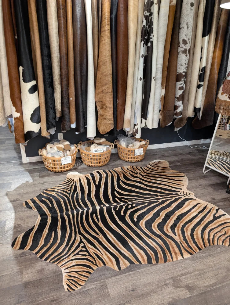 Gorgeous zebra printed large cowhide rug with bold black and tan stripes showcasing unique characteristics by angus oliver
