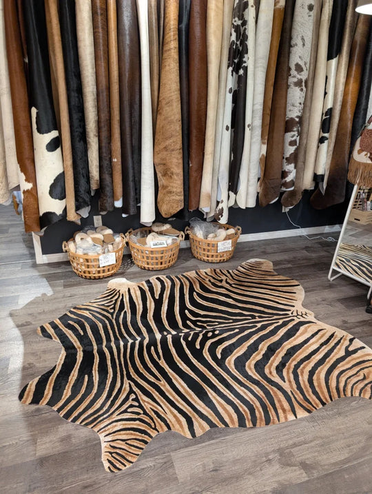 Gorgeous zebra printed large cowhide rug with bold black and tan stripes showcasing unique characteristics by angus oliver
