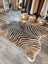 Gorgeous zebra printed large cowhide rug by angus oliver with bold black and tan stripes showing unique characteristics