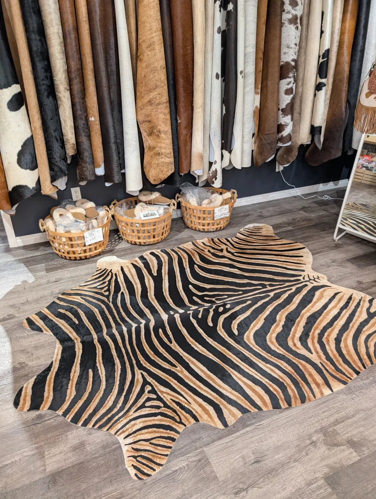 Gorgeous zebra printed large cowhide rug with bold black and tan stripes showing unique characteristics by angus oliver