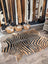 Gorgeous zebra printed large cowhide rug with bold black and tan stripes showing unique characteristics by angus oliver