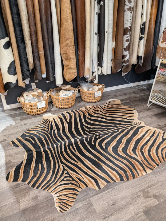 Gorgeous zebra printed large cowhide rug with bold black and tan stripes showing unique characteristics by angus oliver