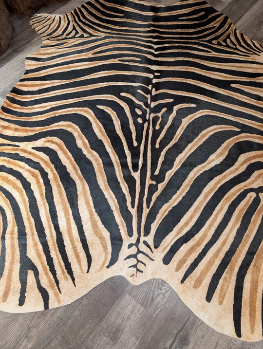 Gorgeous zebra printed cowhide rug by angus oliver with bold black and tan stripes and unique large cowhide characteristics
