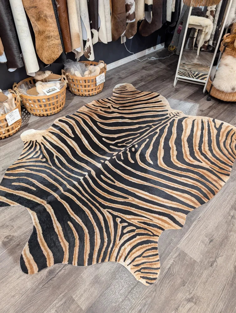 Gorgeous zebra printed large cowhide rug with bold black and tan stripes showcasing unique characteristics by angus oliver