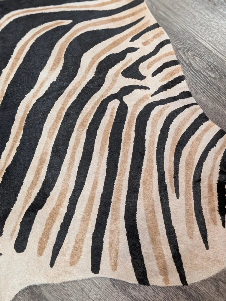 Large cowhide zebra printed faux fur rug in black and beige with unique characteristics by angus oliver