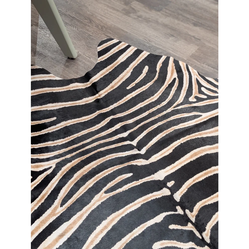 Large cowhide zebra printed faux fur rug in black and beige showcasing unique characteristics by angus oliver