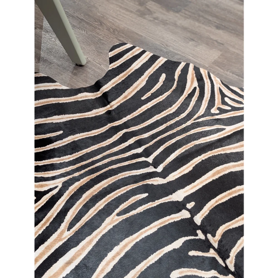 Large cowhide zebra printed faux fur rug in black and beige showcasing unique characteristics by angus oliver