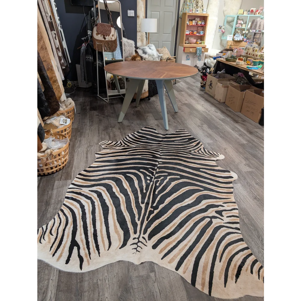 Large cowhide zebra print rug with bold black and tan stripes showcasing unique characteristics by angus oliver