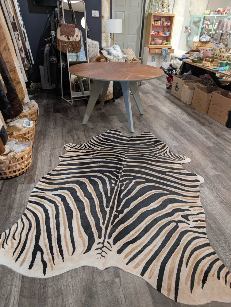 Large cowhide zebra print rug with bold black and tan stripes showcasing unique characteristics by angus oliver