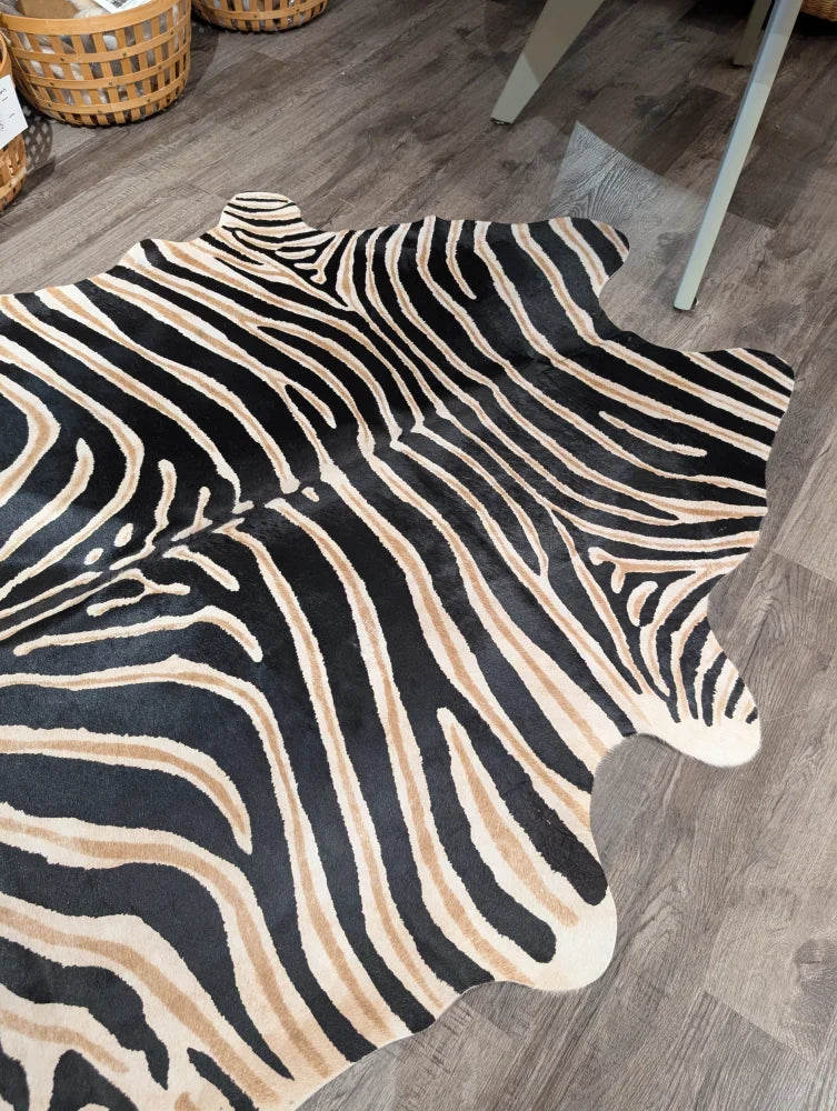 Large cowhide zebra printed faux fur rug in black and beige with unique characteristics by angus oliver