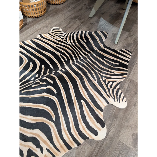 Large cowhide zebra printed faux fur rug in black and beige with unique characteristics by angus oliver