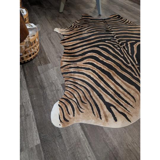 Large cowhide zebra printed faux leather rug with bold black and tan stripes from angus oliver unique characteristics