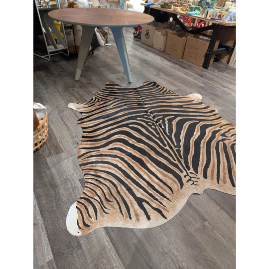 Large cowhide zebra printed rug with bold black and tan stripes featuring unique characteristics by angus oliver