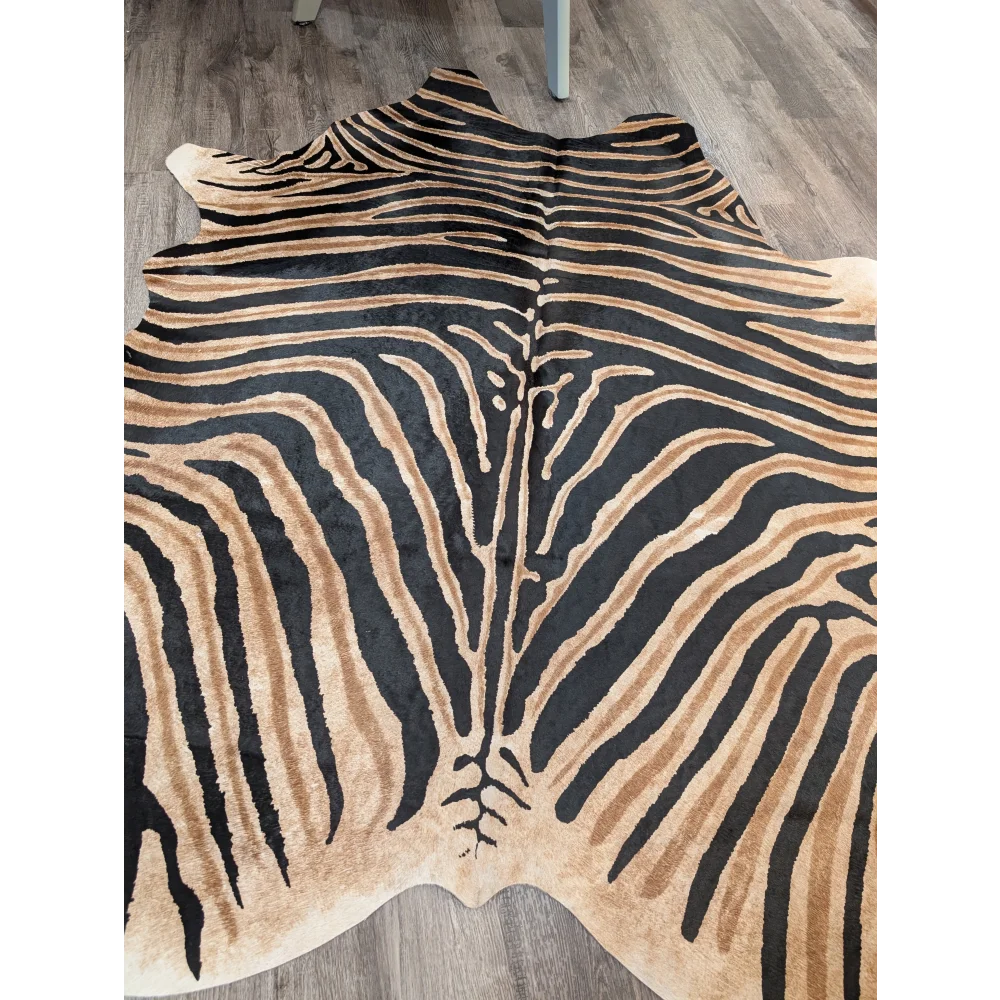 Large cowhide zebra printed faux leather rug in black and tan with unique characteristics by angus oliver