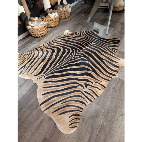 Large cowhide zebra print rug with bold black and tan stripes showing unique characteristics by angus oliver