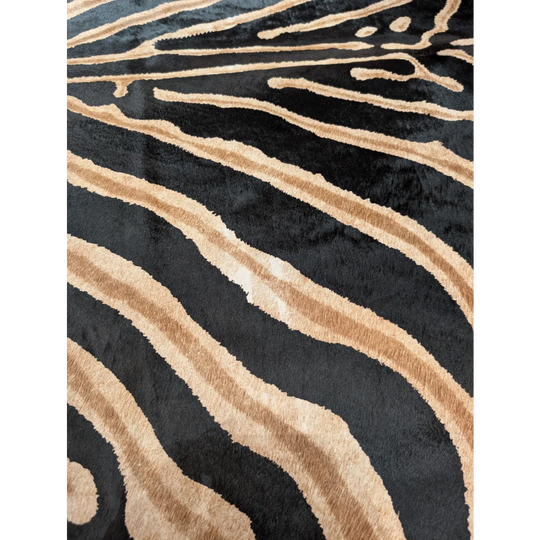 Large cowhide zebra printed plush rug in black and tan with unique characteristics by angus oliver