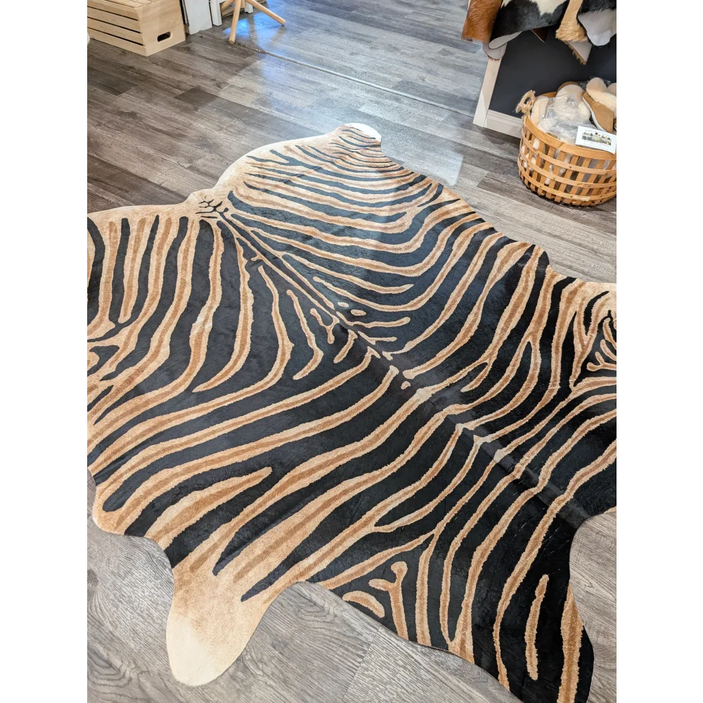 Large cowhide zebra printed rug in black and tan with unique characteristics by angus oliver measuring 83.5 x 73 inches