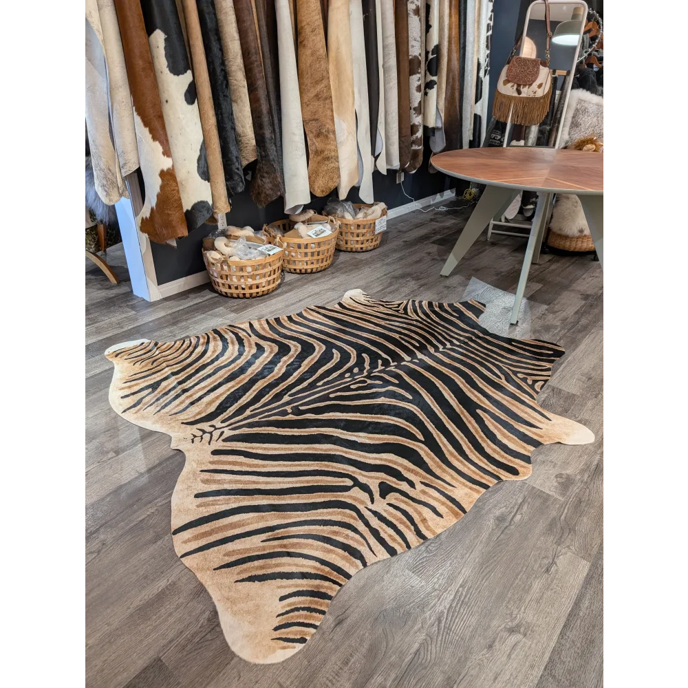 Large cowhide zebra print rug with bold black and tan stripes featuring unique characteristics by angus oliver