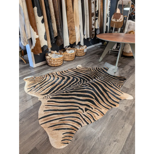 Large cowhide zebra print rug with bold black and tan stripes featuring unique characteristics by angus oliver