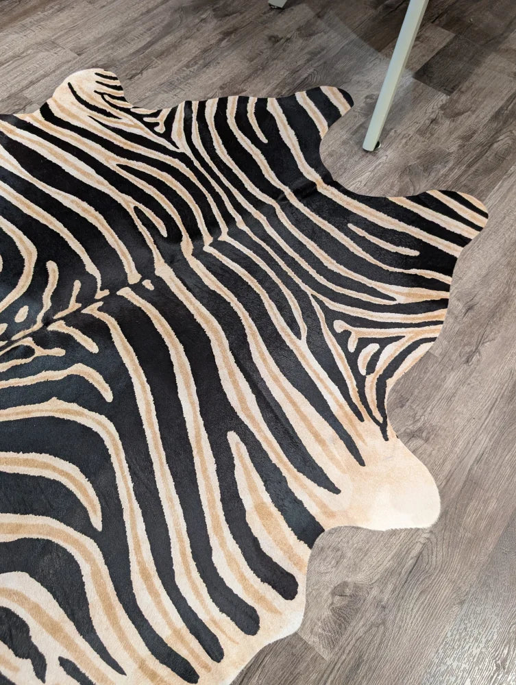 Large cowhide zebra printed faux leather rug in black and beige with unique characteristics by angus oliver