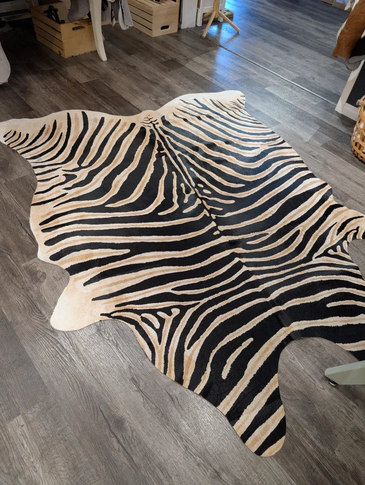 Large cowhide zebra printed rug in black and cream with unique characteristics by angus oliver 90 x 70 inches