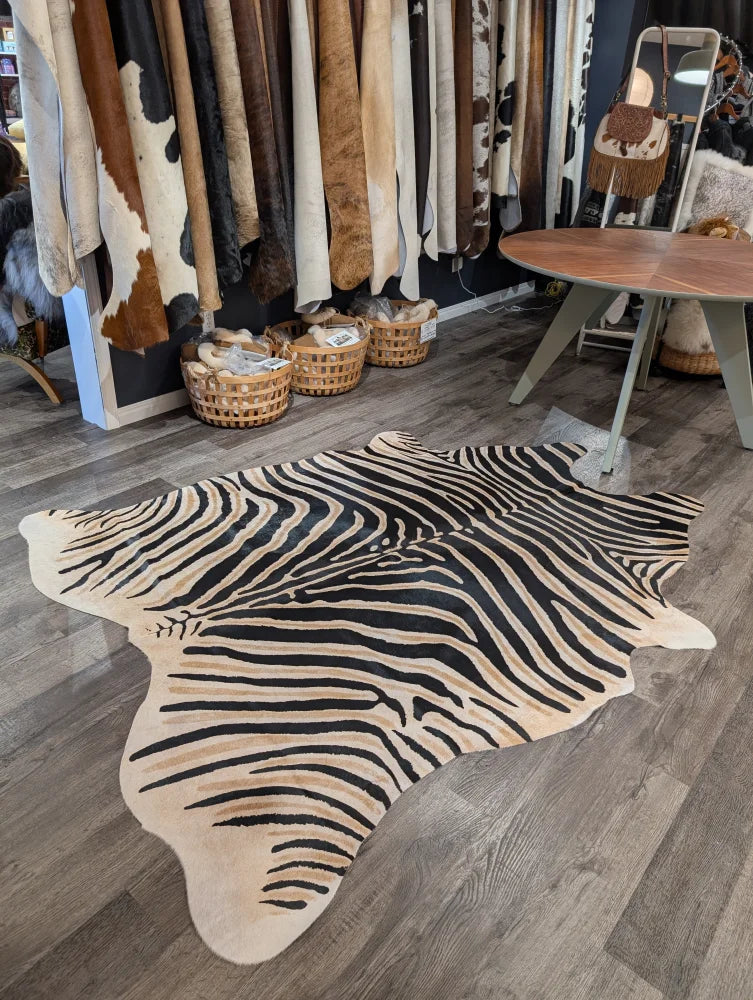 Large cowhide zebra print cowhide rug with bold black and beige stripes showcasing unique characteristics by angus oliver