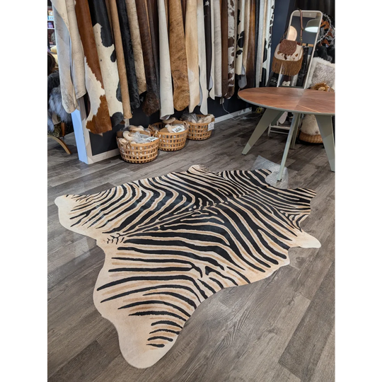 Large cowhide zebra print cowhide rug with bold black and beige stripes showcasing unique characteristics by angus oliver