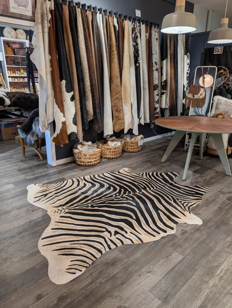 Large black and cream zebra printed cowhide rug with unique characteristics by angus oliver perfect as a statement piece