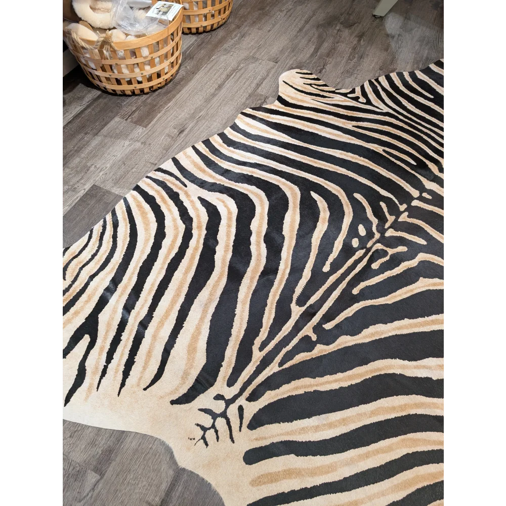 Large cowhide faux leather rug with unique black and beige zebra stripes by angus oliver perfect for bold decor